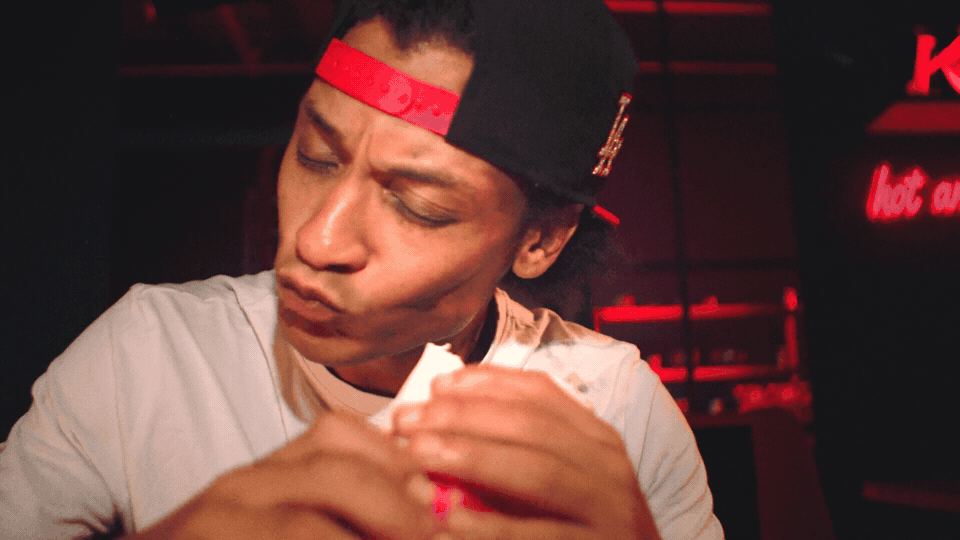 A man doing the Boneless Bounce while eating